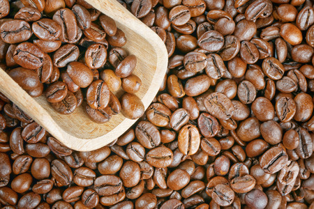 top view closeup coffee beans wood scoop の写真素材