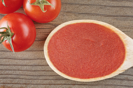 top view closeup tomato sauce on wood backgroundの写真素材