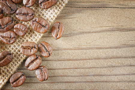 closeup top view coffee beans on wood backgroundの写真素材