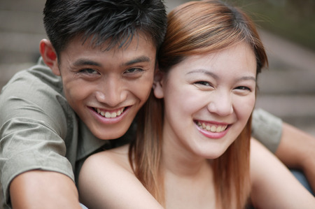 Couple smiling, looking at camera.の写真素材