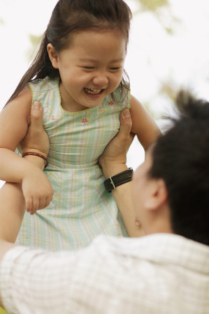 Father carrying young daughter.の写真素材