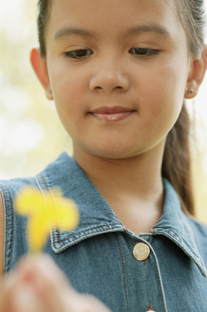 Young girl holding a flowerの写真素材