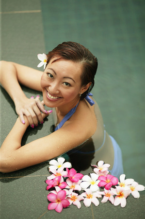 Young woman in a  swimming pool, high angle viewの写真素材