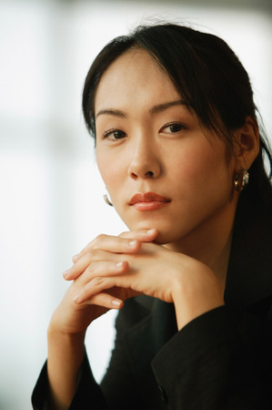 Young woman, hands on chinの写真素材