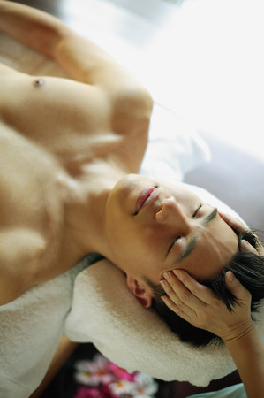 Young man receiving head massageの写真素材