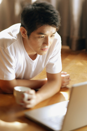 Young man looking at laptop,の写真素材