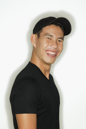 Young man looking at camera, smilingの写真素材
