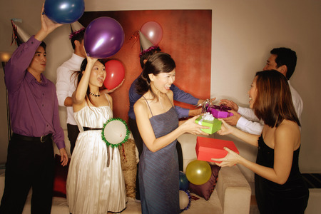 Group of friends exchanging giftsの写真素材