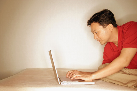 Man using laptop, sideviewの写真素材
