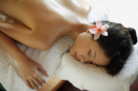 Young woman receiving back massageの写真素材