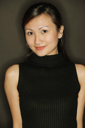 Young woman wearing a black top, looking at cameraの写真素材