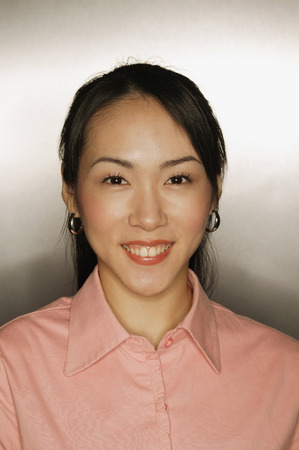 Young woman, looking at camera, smilingの写真素材