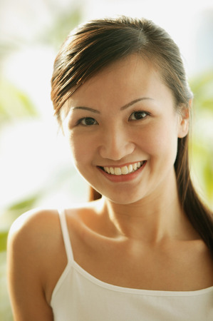 Young woman looking at camera, smilingの写真素材