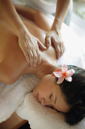 Young woman receiving back massage, eyes closedの写真素材