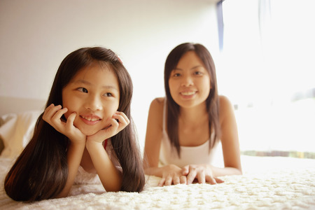 Mother and daughter, looking on front, looking at cameraの写真素材