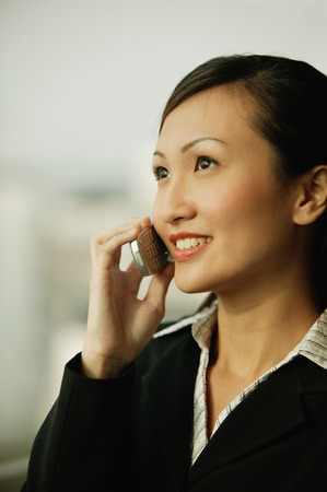Young woman on mobile phone, smilingの写真素材