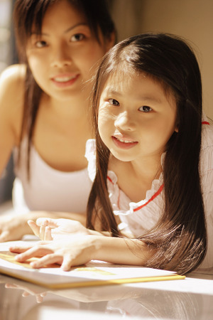 Mother and daughter, looking at cameraの写真素材