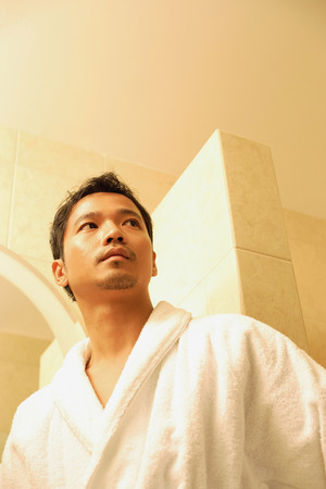 Young man in robe looking awayの写真素材