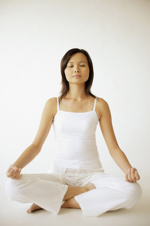 Young woman sitting in lotus positionの写真素材