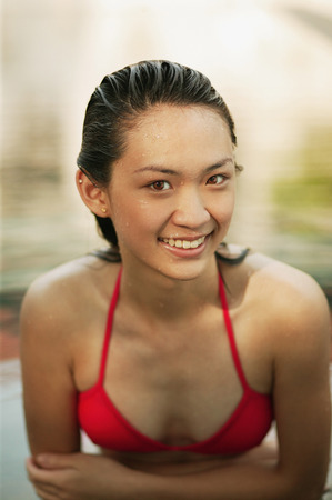 Young woman in a  swimming pool, smilingの写真素材