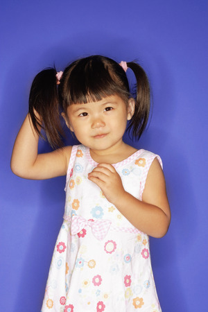 Young girl, with hand behind headの写真素材