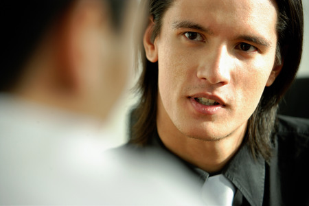 Two men talking, face to face