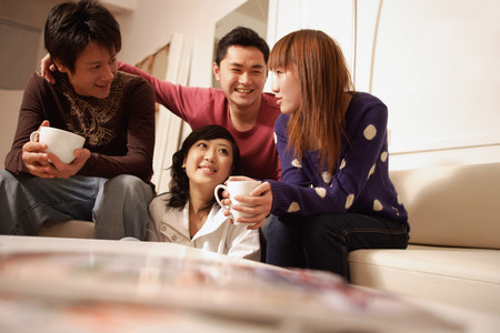 Friends sitting around at home