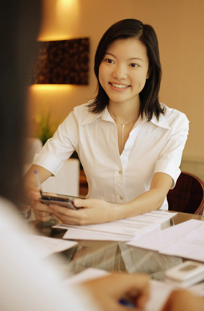 Young female executive smiling, another female in front of her.の写真素材