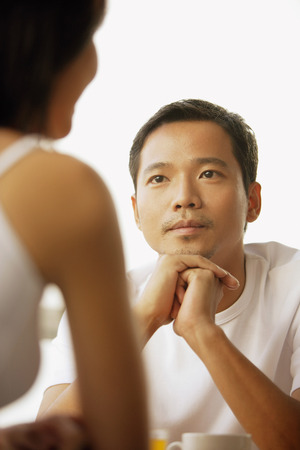 Young man and woman talking, face to faceの写真素材