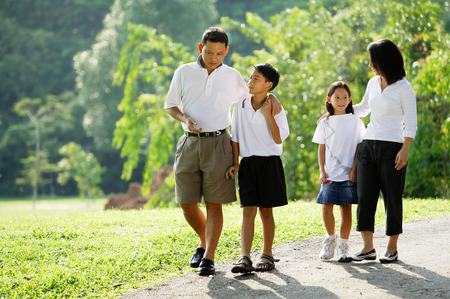 Family with two children, walking in parkの写真素材