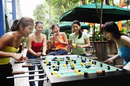 Young women playing foosball