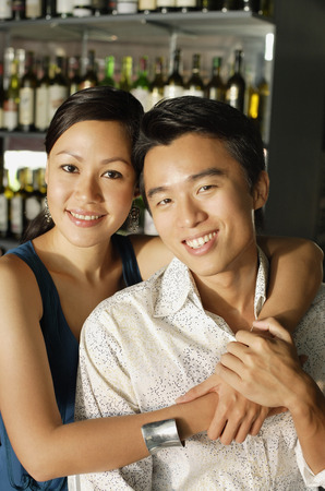 Couple at bar, smiling at cameraの写真素材