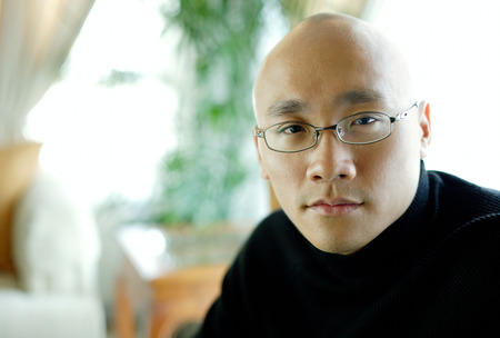 Man in black turtleneck, looking at camera, portraitの写真素材