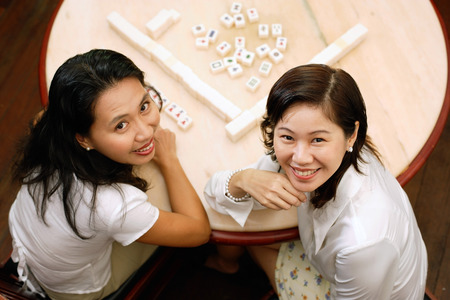 Women at mahjong table, looking at camera, high angle viewの写真素材