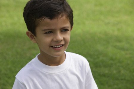 Little boy in white tee shirt, at park