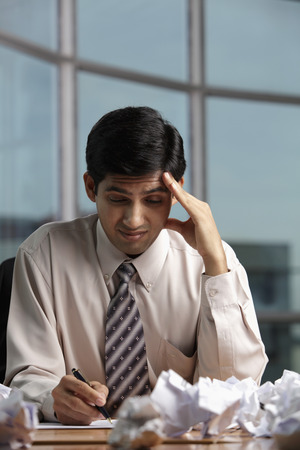 Indian man stressed at workの写真素材