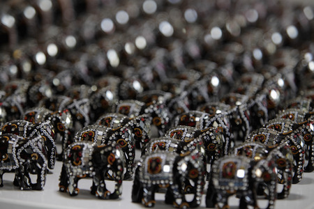 Rows of elephant figurines decorated with mirrors and beadsの写真素材