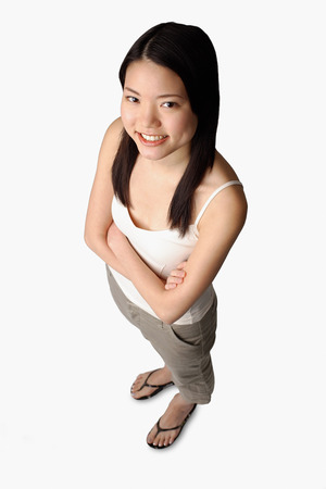 Young woman looking at camera, arms crossedの写真素材