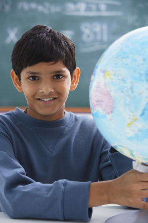 boy holding globe, gray sweatshirtの写真素材