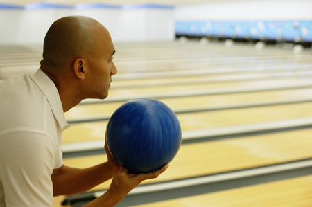 Man holding bowling ball, preparing to bowlの写真素材