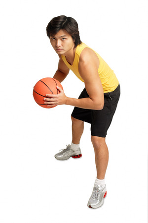 Man holding basketball, preparing to shootの写真素材