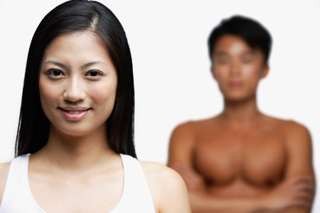 Woman smiling at camera, person in the backgroundの写真素材