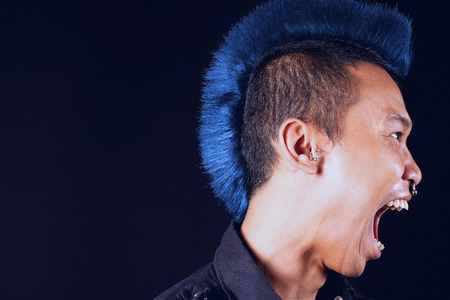 Man with mohawk, side view, mouth openの写真素材