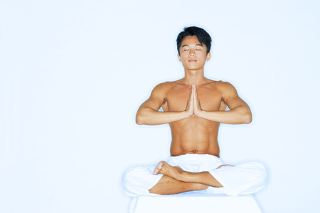 Man practicing yoga, meditatingの写真素材