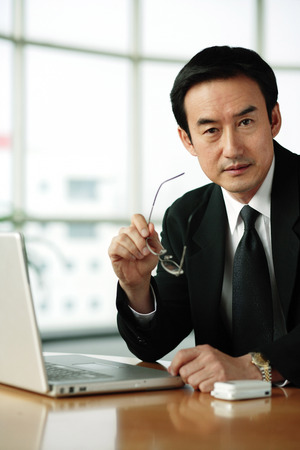 Businessman looking at camera, portraitの写真素材