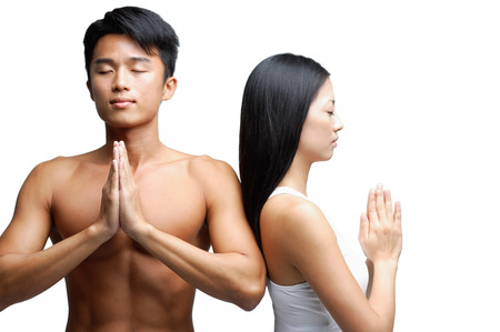 Couple doing yoga, side by side, man facing camera, woman facing awayの写真素材