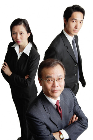 Executives looking at camera, serious expressionsの写真素材