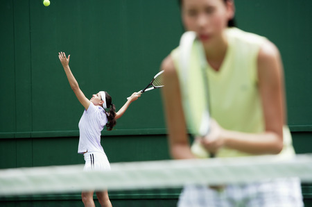 Women playing tennis togetherの写真素材