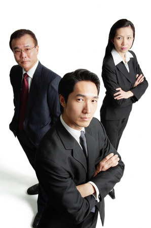 Executives looking at camera, serious expressionsの写真素材