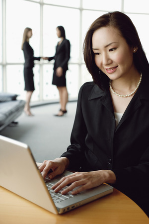 Portrait of businesswoman using laptopの写真素材